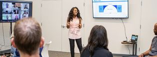 woman presenting in front of audience